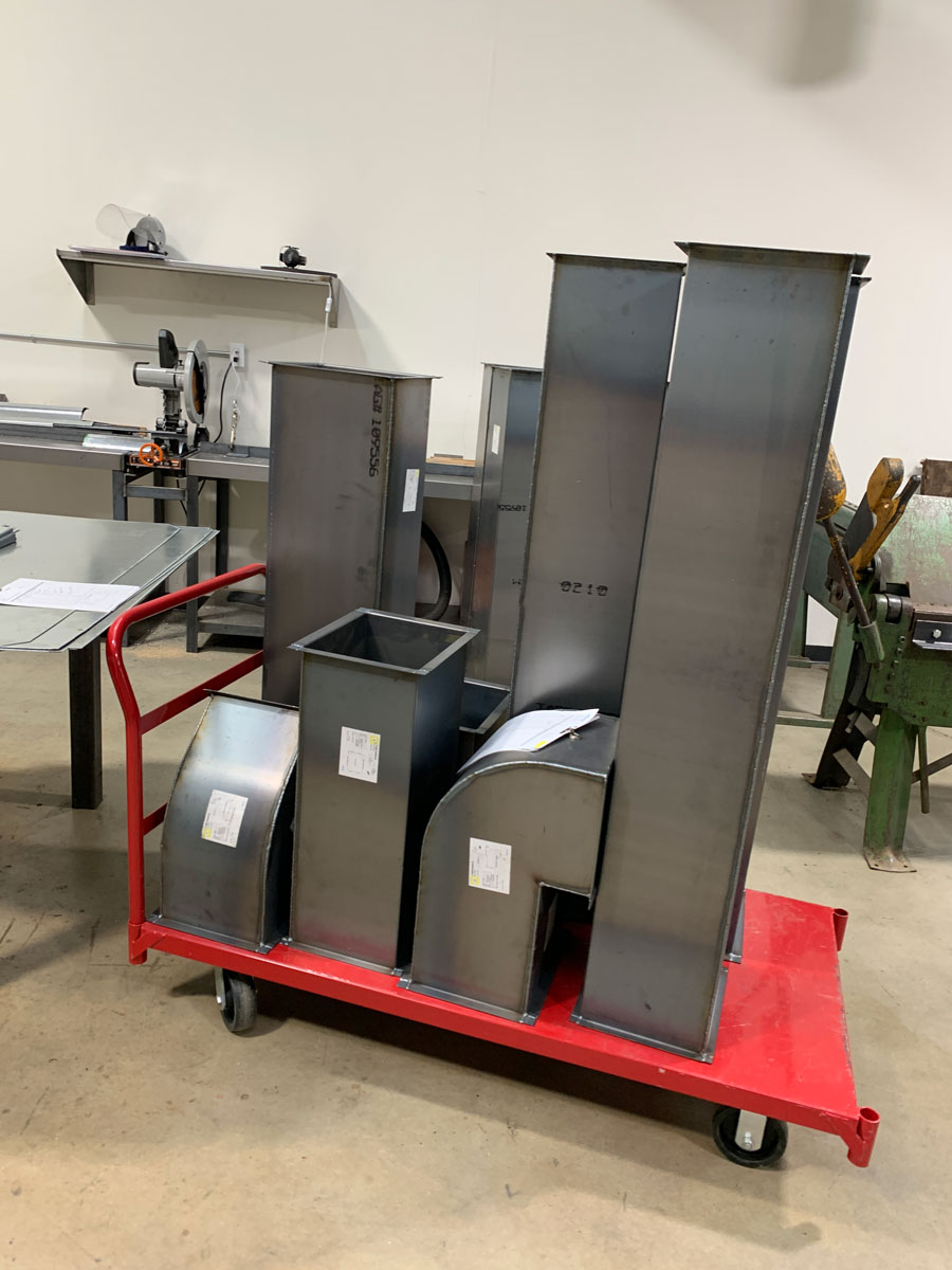 Ductwork fittings on a red cart